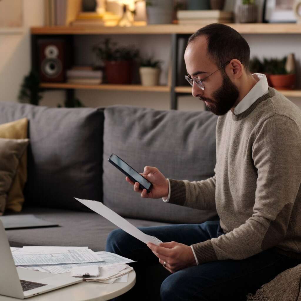 Business owner looking over a promissory note as a Texas legal option when a client doesn’t pay